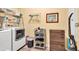 This laundry room features a washer and dryer, ample storage, and a convenient storage rack at 3365 Sweetwater Dr, Cumming, GA 30041