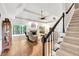Inviting living room with wood floors, a fireplace, and a staircase leading to the upper level at 3365 Sweetwater Dr, Cumming, GA 30041