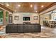This living room features a wood ceiling, exposed stone, and large picture windows at 3365 Sweetwater Dr, Cumming, GA 30041