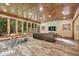 This living room features a wood ceiling, exposed stone, and large picture windows at 3365 Sweetwater Dr, Cumming, GA 30041