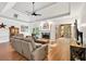 Bright living room featuring a fireplace, tray ceiling, and access to the outdoor patio at 3365 Sweetwater Dr, Cumming, GA 30041