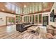 This living room features a wood ceiling, exposed stone, and large picture windows at 3365 Sweetwater Dr, Cumming, GA 30041