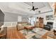 Inviting living room with wood floors, ceiling fan, and comfortable seating arrangement at 3365 Sweetwater Dr, Cumming, GA 30041
