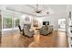 Open living room with fireplace, large windows, and hardwood floors throughout at 3365 Sweetwater Dr, Cumming, GA 30041