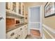 This pantry features granite countertops, ample storage, and decorative glass door cabinets at 3365 Sweetwater Dr, Cumming, GA 30041