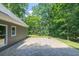 Large, paved patio area surrounded by lush greenery provides a relaxing outdoor space at 3365 Sweetwater Dr, Cumming, GA 30041