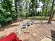 View of backyard from raised deck with wooden fence, lush trees, and firepit area at 3460 Ebenezer Rd, Marietta, GA 30066