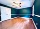 Bedroom with green walls, wood-look flooring, ceiling fan, and natural light at 3460 Ebenezer Rd, Marietta, GA 30066