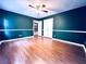 Bedroom featuring green walls, wood-look flooring, closet, and ceiling fan at 3460 Ebenezer Rd, Marietta, GA 30066
