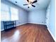Bedroom with light gray walls, vinyl floors, a ceiling fan, and natural lighting at 3460 Ebenezer Rd, Marietta, GA 30066