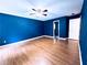 Bedroom showcasing blue walls, wood-look flooring, and a ceiling fan at 3460 Ebenezer Rd, Marietta, GA 30066