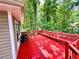 Large open deck with built-in bench seating surrounded by mature trees at 3460 Ebenezer Rd, Marietta, GA 30066