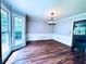 Spacious dining room with large windows, wood floors, and modern chandelier at 3460 Ebenezer Rd, Marietta, GA 30066