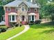 Charming two-story brick home with stone accents, mature trees, and a well-manicured lawn at 3460 Ebenezer Rd, Marietta, GA 30066