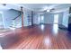 Bright and airy living room with wood floors, a fireplace, and easy access to the staircase at 3460 Ebenezer Rd, Marietta, GA 30066