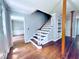 Staircase featuring wood treads, white risers, and exposed post beam at 3460 Ebenezer Rd, Marietta, GA 30066