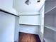 Spacious walk-in closet with shelving and rack, complemented by wood-look flooring at 3460 Ebenezer Rd, Marietta, GA 30066