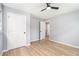 This bedroom has wood floors, gray walls, a ceiling fan, and access to another room at 2621 Walton Sw Way, Marietta, GA 30060