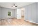 Bedroom with wood floors, accent wall, and a view of the landscape outside a window at 2621 Walton Sw Way, Marietta, GA 30060