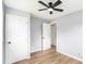 This bedroom has light wood flooring, a ceiling fan, and white doors at 2621 Walton Sw Way, Marietta, GA 30060