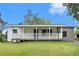 Charming single-story home with a welcoming front porch and well-maintained lawn at 2621 Walton Sw Way, Marietta, GA 30060