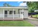The home's covered porch has a wooden floor and a freshly-mowed lawn in front at 2621 Walton Sw Way, Marietta, GA 30060