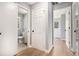 Hallway view featuring gray walls, white doors, and wood-look vinyl flooring at 2621 Walton Sw Way, Marietta, GA 30060