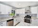 Updated kitchen features white cabinets, granite countertops, and stainless steel appliances at 2621 Walton Sw Way, Marietta, GA 30060