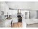 Well-lit kitchen with white cabinetry, granite countertops, an island, and stainless steel appliances at 2621 Walton Sw Way, Marietta, GA 30060