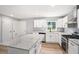 Bright kitchen with white cabinets, granite countertops, stainless steel appliances, and island at 2621 Walton Sw Way, Marietta, GA 30060