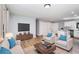 A modern living room with hardwood floors, a TV, furniture, and a view of the kitchen at 2621 Walton Sw Way, Marietta, GA 30060