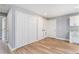 A light gray living room has a closet, hardwood floors, and a doorway leading to another room at 2621 Walton Sw Way, Marietta, GA 30060
