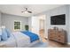 A bedroom featuring wood floors, gray accent wall, and a view into another room at 2621 Walton Sw Way, Marietta, GA 30060
