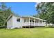 The backyard with the home's porch is surrounded by a well-maintained lawn at 2621 Walton Sw Way, Marietta, GA 30060