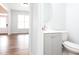 View of a modern half bath featuring a white cabinet and sink at 264 Ascott Ln, Woodstock, GA 30189