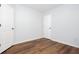 Room features wood flooring, natural light, and white doors at 264 Ascott Ln, Woodstock, GA 30189