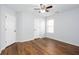 A cozy bedroom with a ceiling fan and wood floor illuminated by natural light at 264 Ascott Ln, Woodstock, GA 30189