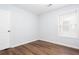 A simple bedroom with vinyl flooring and a window at 264 Ascott Ln, Woodstock, GA 30189