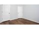 Clean bedroom features durable, modern hardwood flooring and white doors at 264 Ascott Ln, Woodstock, GA 30189