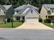 Charming two-story home with a well-manicured lawn and a two-car garage at 264 Ascott Ln, Woodstock, GA 30189