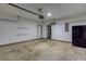 A two car garage features storage shelves and a refrigerator at 264 Ascott Ln, Woodstock, GA 30189