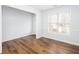 Open-concept living area features hardwood floors and a large window at 264 Ascott Ln, Woodstock, GA 30189