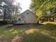 A sunny view of the back of the house with a small deck and fenced yard at 4720 Fowler Cir, Acworth, GA 30101
