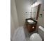 Bathroom with toilet, vanity, framed mirror, and dark fixtures on marble tile floors at 4720 Fowler Cir, Acworth, GA 30101