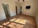 Sunlit bedroom with hardwood floors, tv, and multiple doorways at 4720 Fowler Cir, Acworth, GA 30101