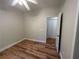 This bedroom features hardwood floors, a ceiling fan, and a closet for storage at 4720 Fowler Cir, Acworth, GA 30101