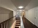 Hallway with hardwood floors, neutral walls and view of the staircase at 4720 Fowler Cir, Acworth, GA 30101