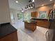Modern kitchen with granite countertops, stainless steel appliances, kitchen island, and white tiled flooring at 4720 Fowler Cir, Acworth, GA 30101