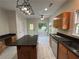 Well-appointed kitchen with granite countertops, stainless steel appliances, a center island, and white tiled flooring at 4720 Fowler Cir, Acworth, GA 30101