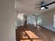 Open concept living room featuring hardwood floors, neutral paint, modern ceiling fan, and bright natural light at 4720 Fowler Cir, Acworth, GA 30101